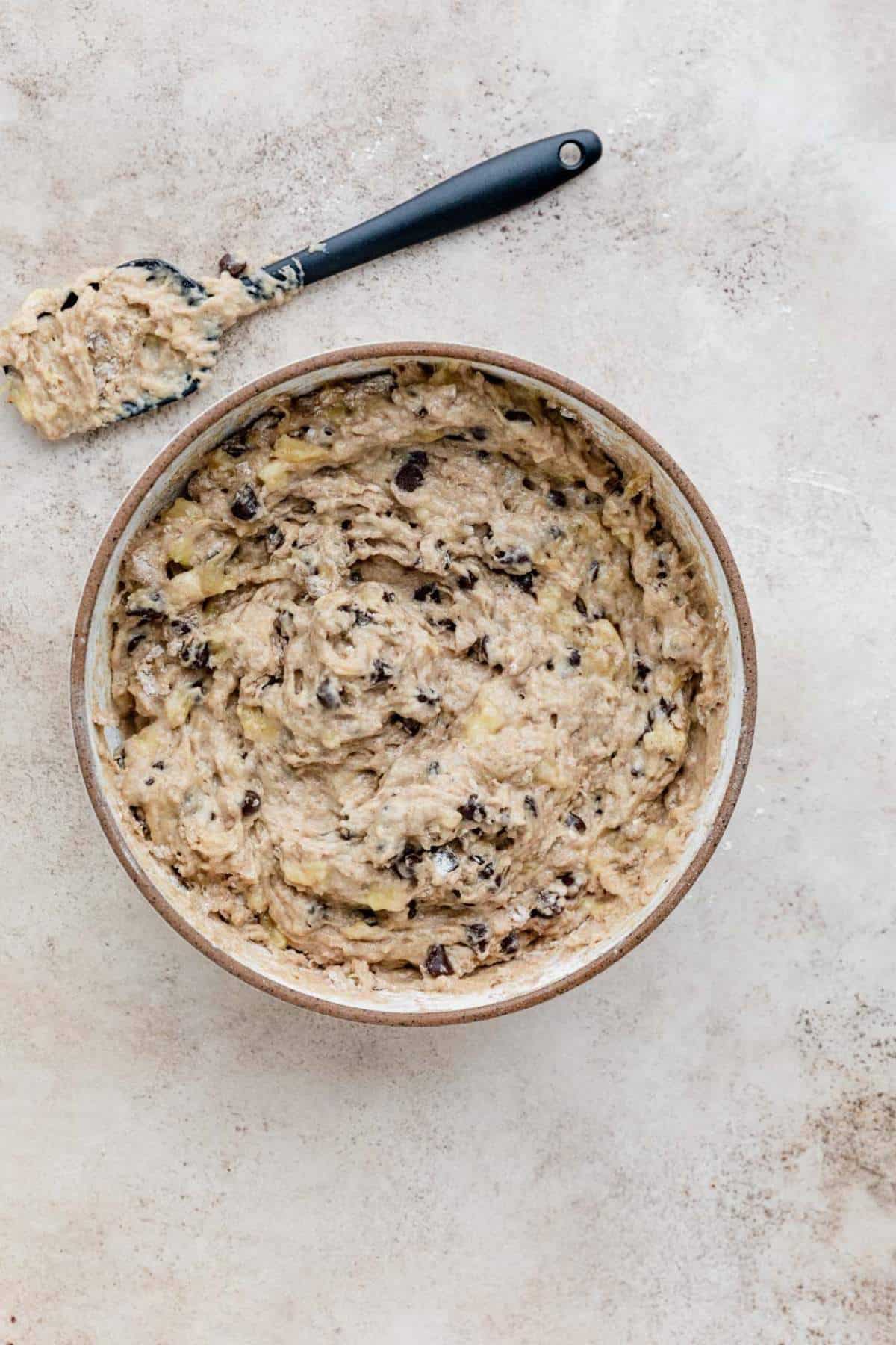 Muffin batter with chocolate chips in a large bowl.