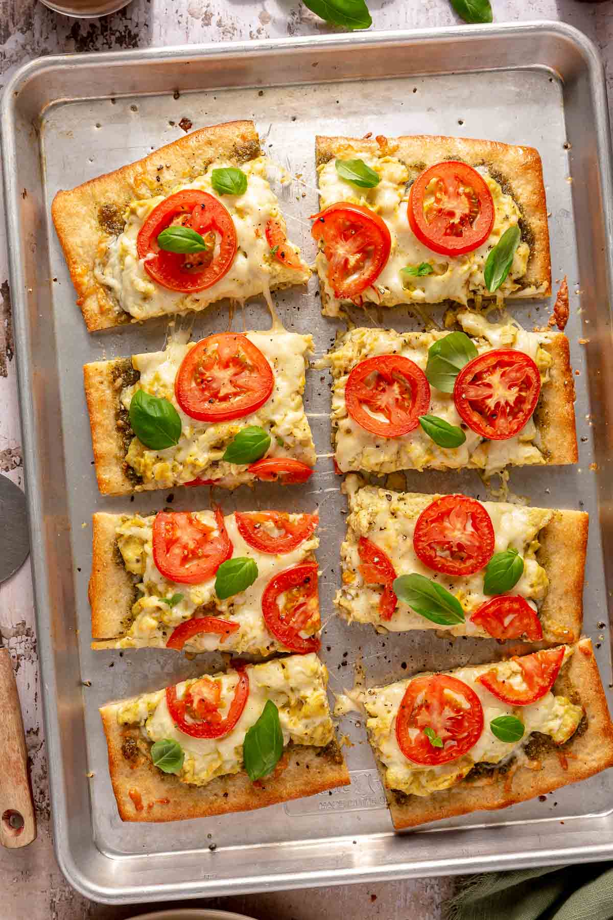 Breakfast pizza on a baking sheet.