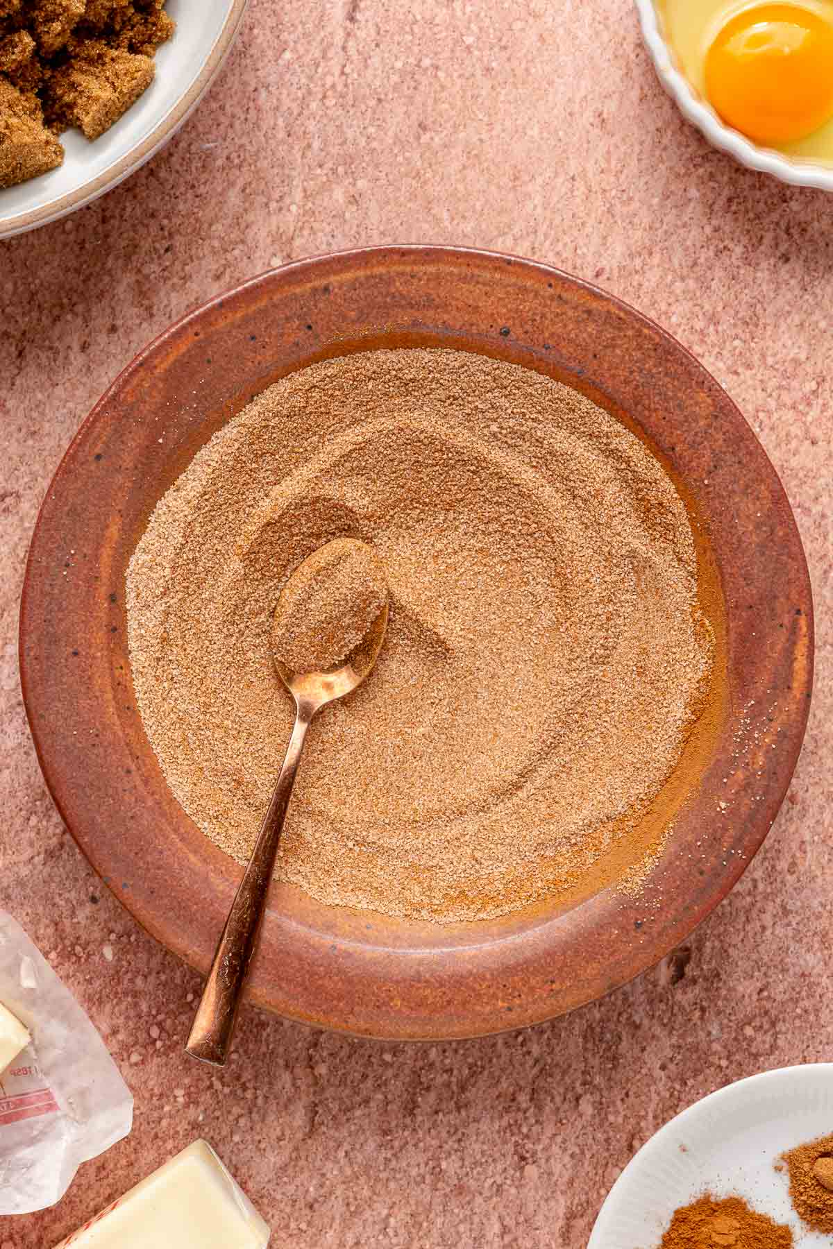 Stirring together cinnamon and sugar in a small bowl.