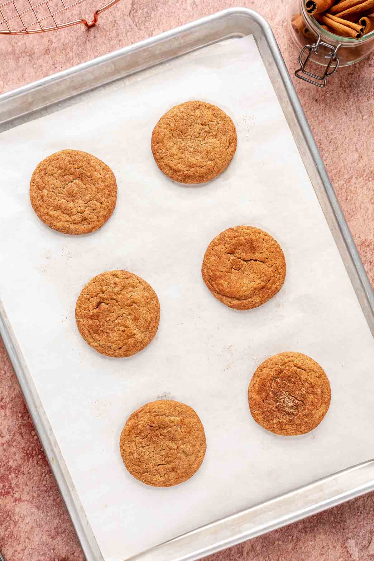 Baked cookies on a parchment lined cookie sheet.