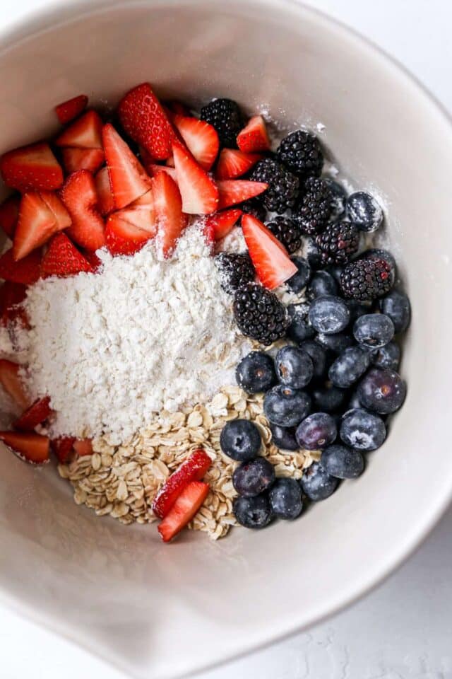 Combining berries with oats and flour.