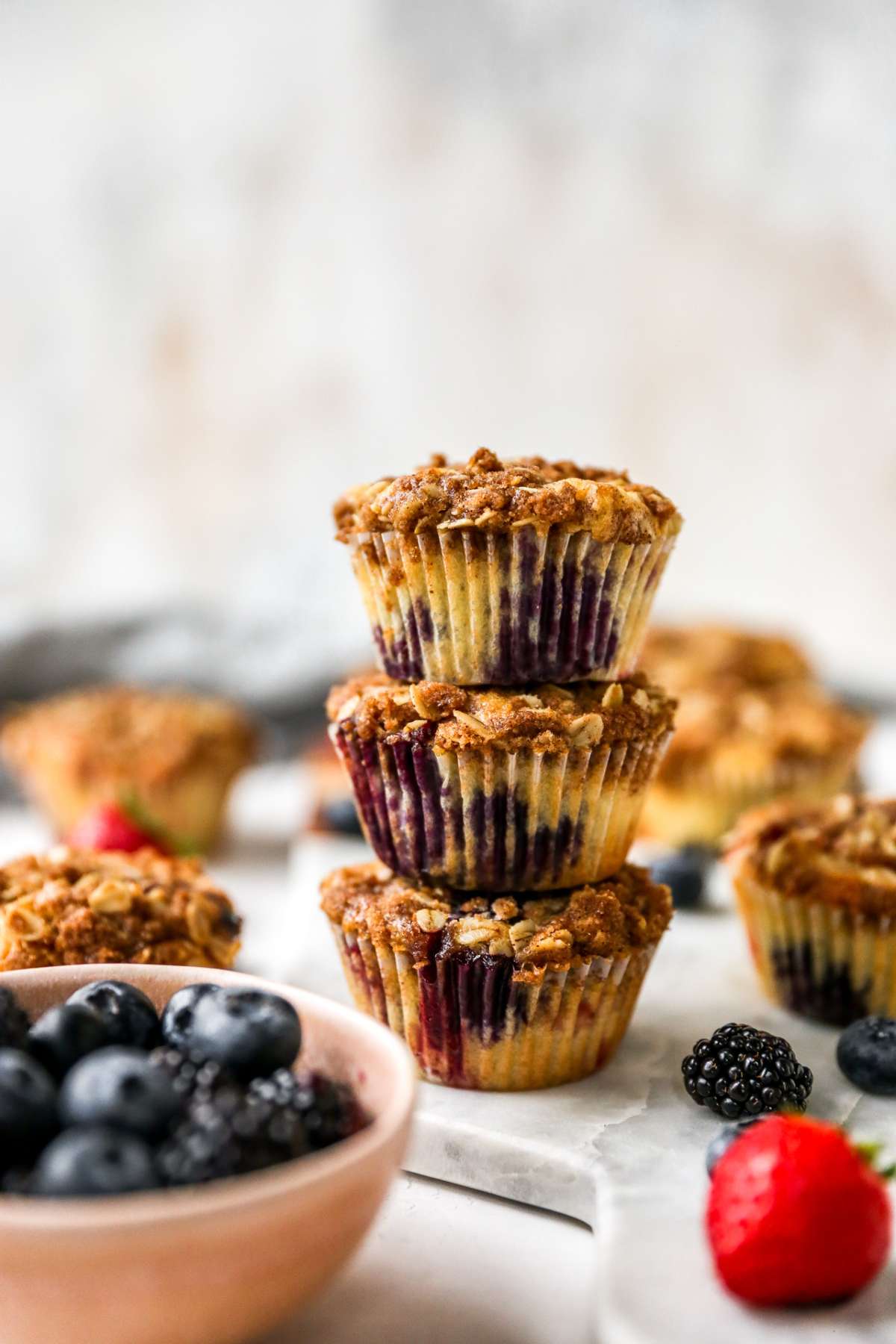 Three berry muffins stacked.