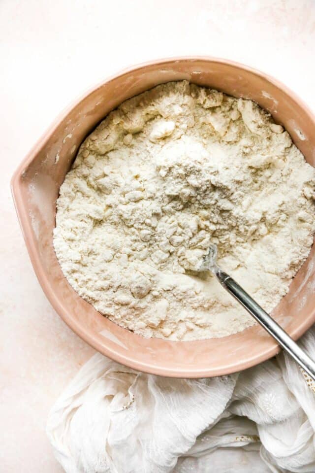 Stirring butter into flour mixture.