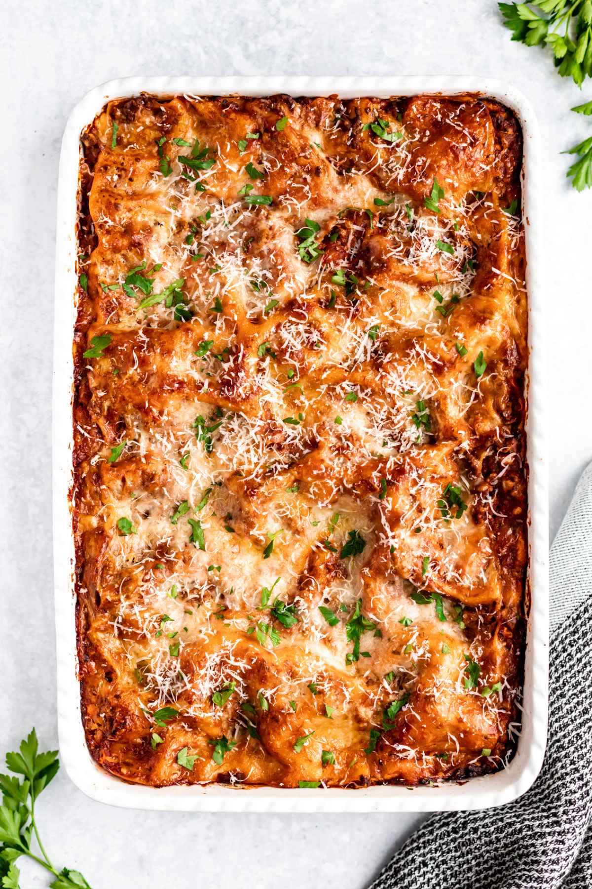 Easy lasagna recipe baked in a large white casserole dish.