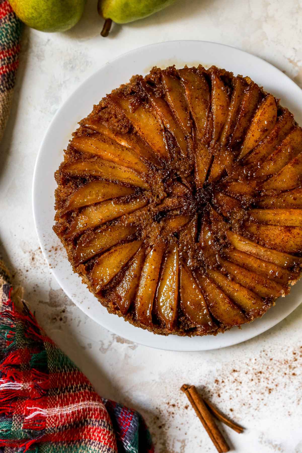 Spice cake topped with thin slices of pears and brown sugar.