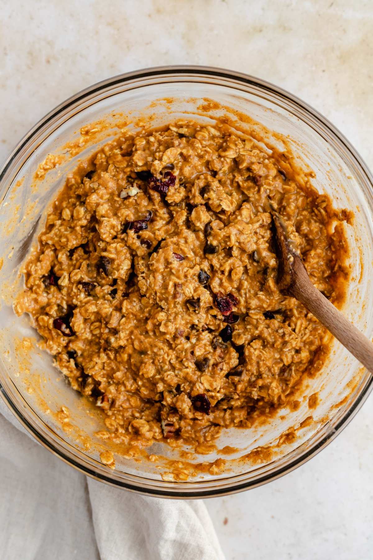 Stirring together oats with pumpkin and chocolate chips in a large bowl.