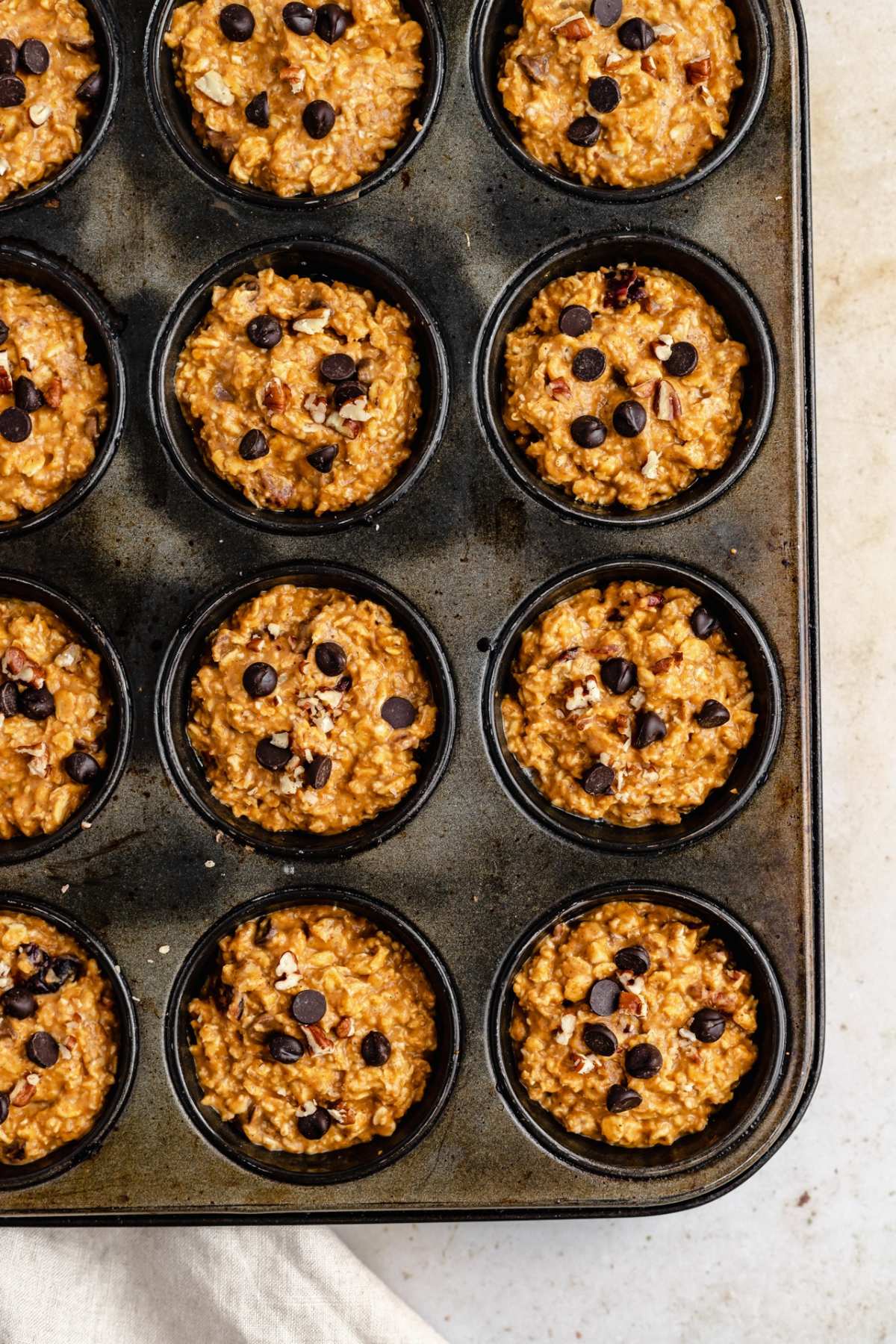 Muffin batter in a muffin pan.