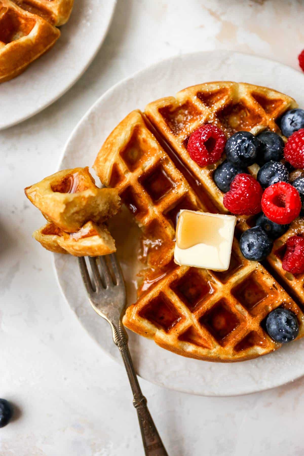 A bite of waffle on a fork.