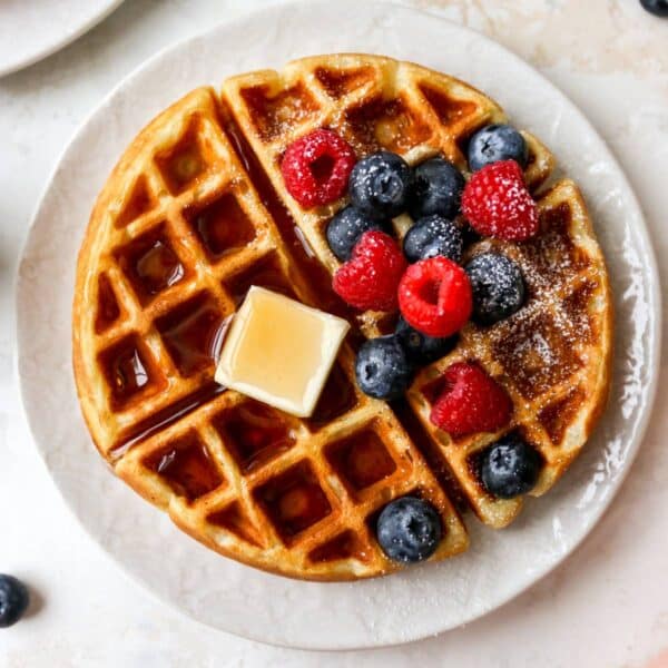 Buttermilk waffles topped with butter, maple syrup and fresh berries.