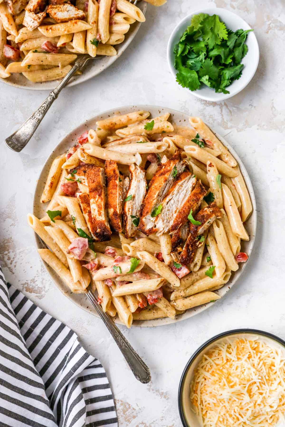 Creamy chicken pasta served on a plate with a fork.