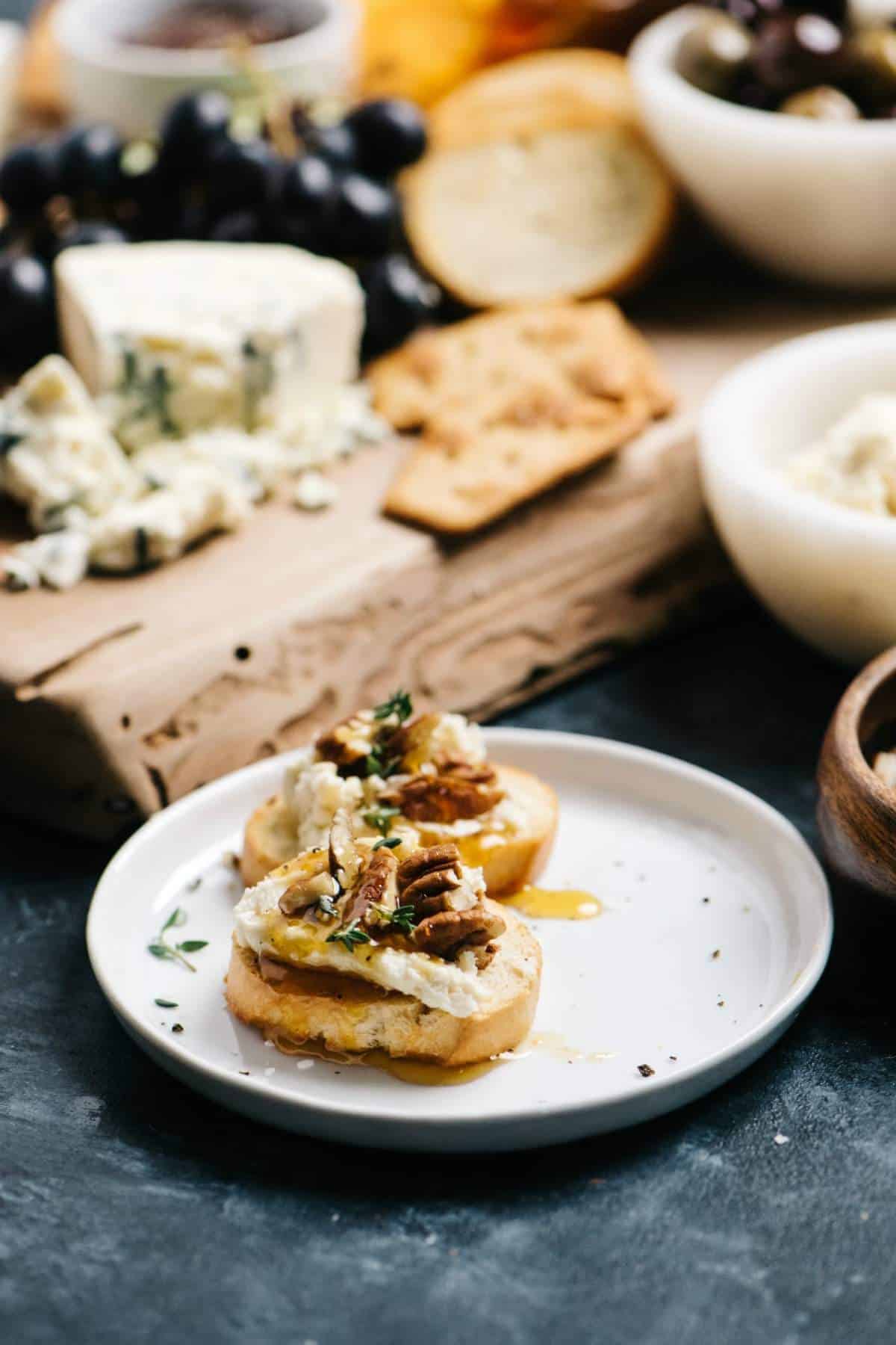 Goat cheese on a crostini with honey, pecans and thyme.