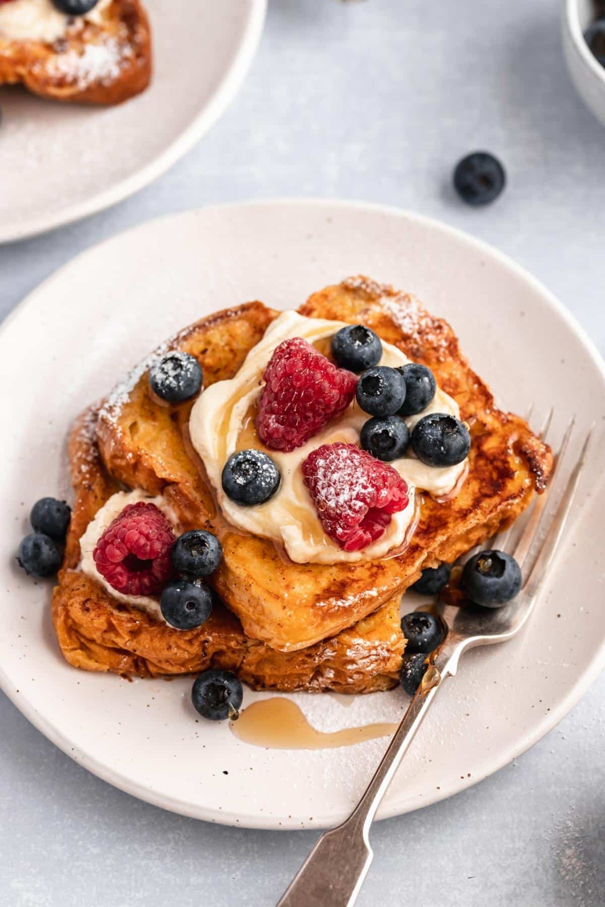 Brioche French toast topped with yogurt and berries.