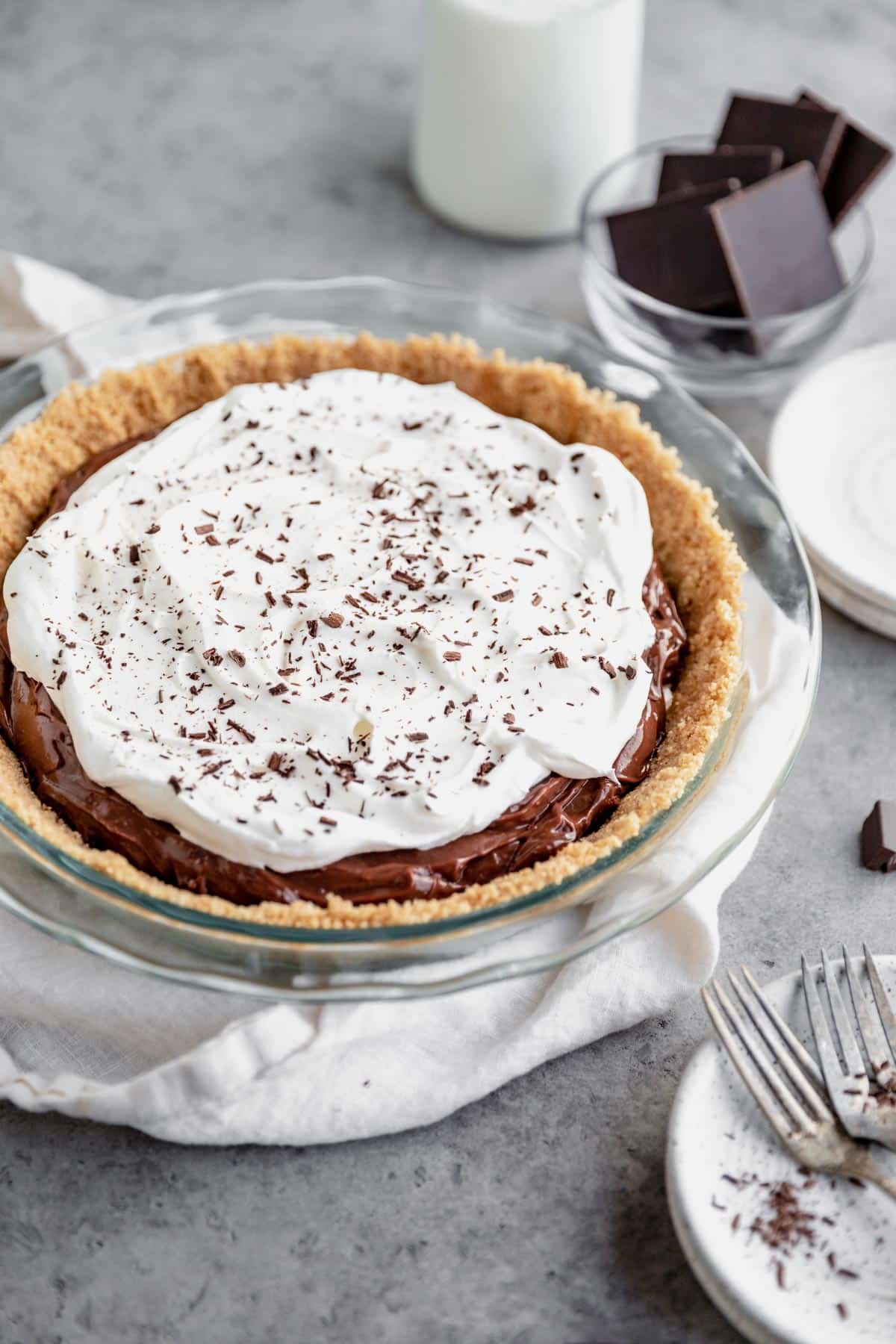 Pudding pie in a graham cracker crust served in a pie plate.