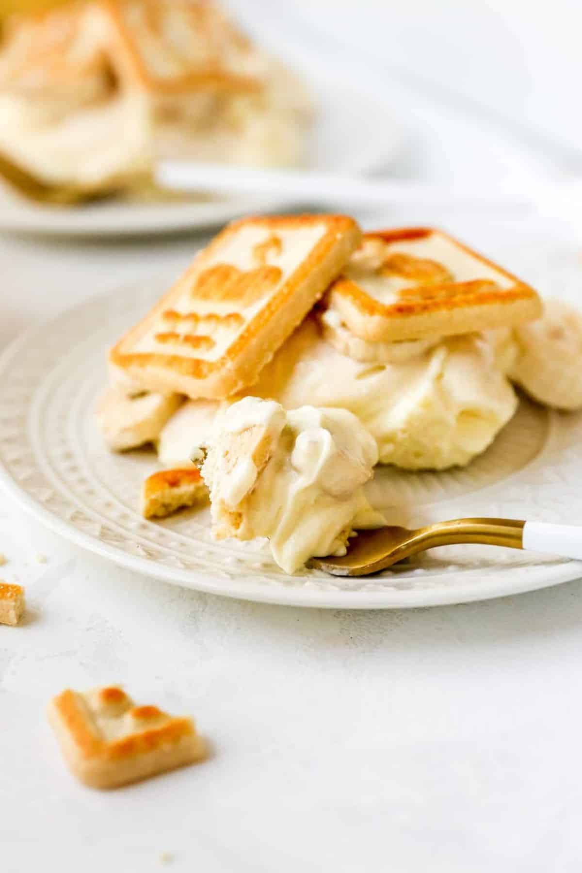 Dessert made with chessman cookies on a white plate with a fork.