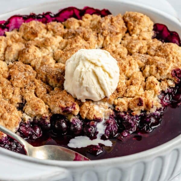 Blueberry cobbler topped with a scoop of ice cream.