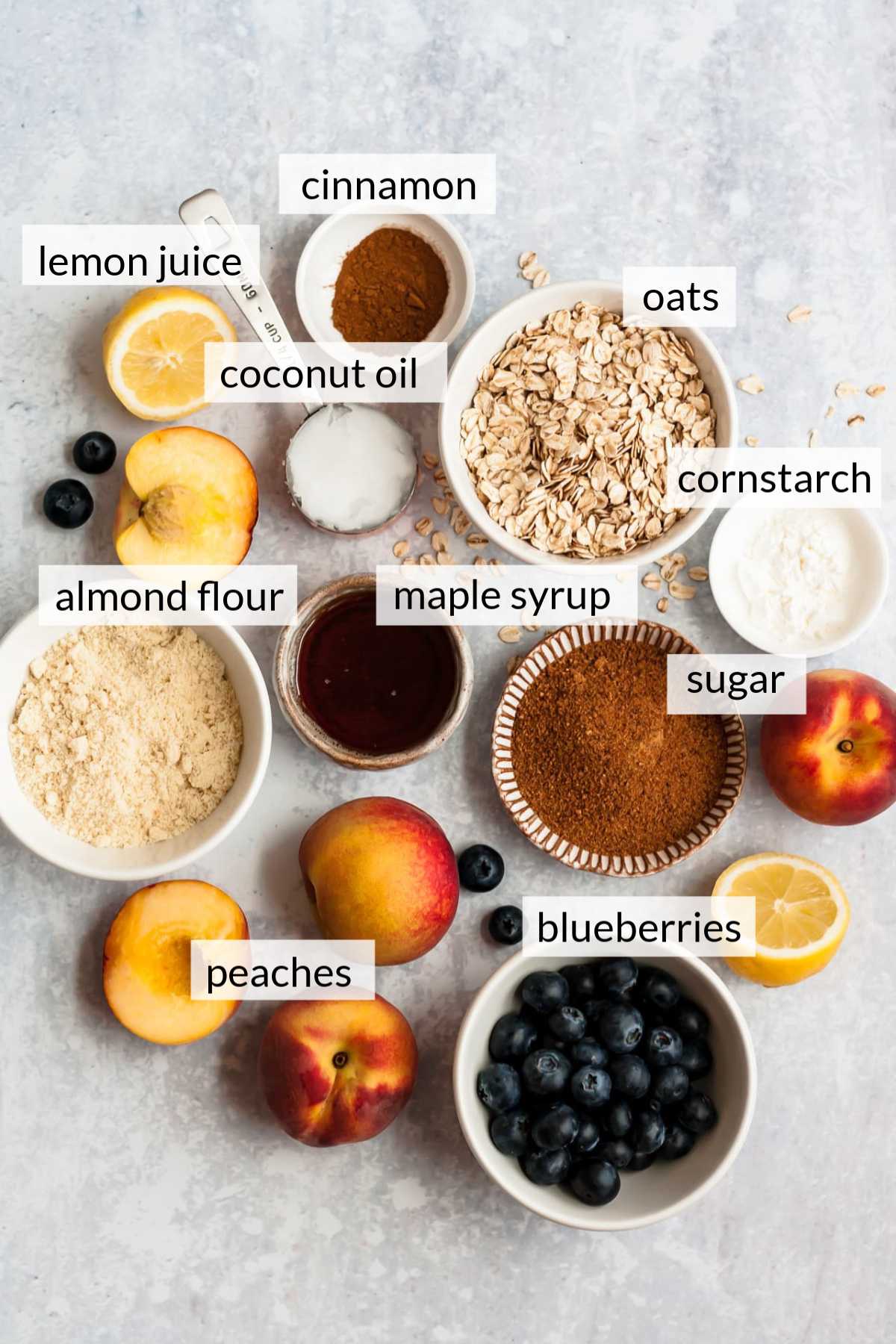 Small bowls with blueberries, sugar, maple syrup, almond flour and oats.