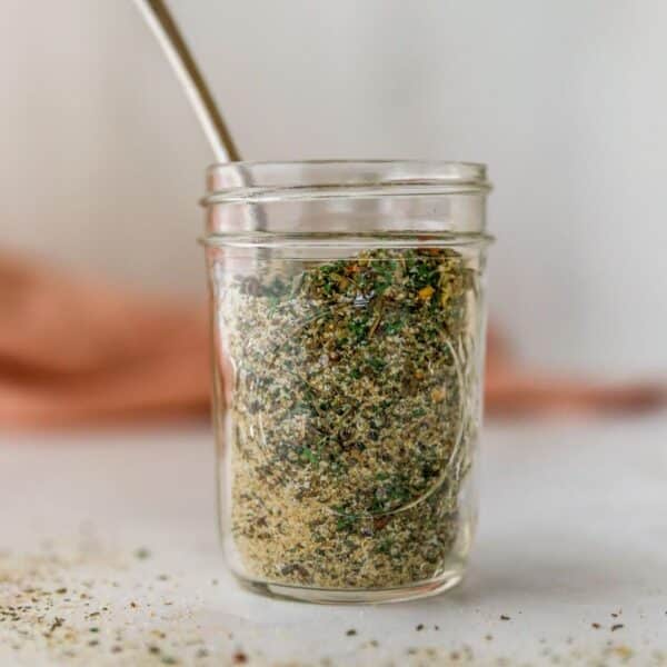 Homemade Italian seasoning in a small glass jar.