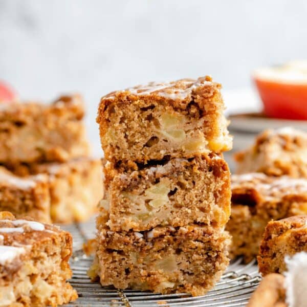 Three pieces of apple coffee cake stacked.