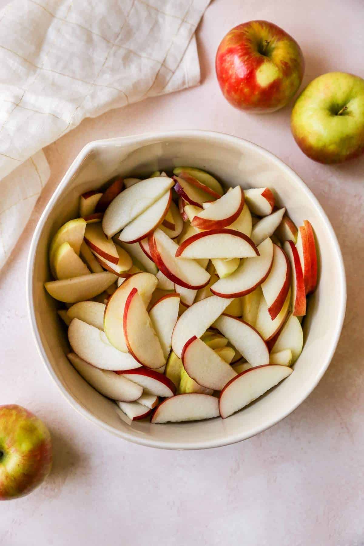 Thinly sliced apples in a bowl.