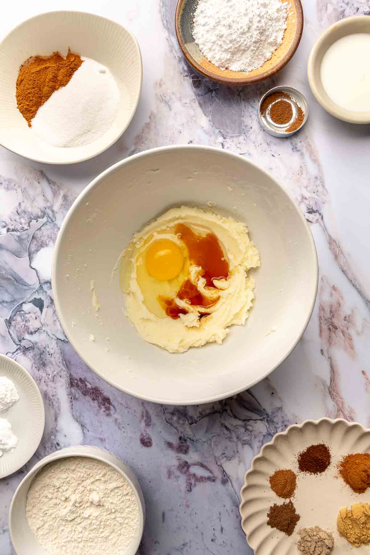 Adding egg and vanilla to butter and sugar mixture.