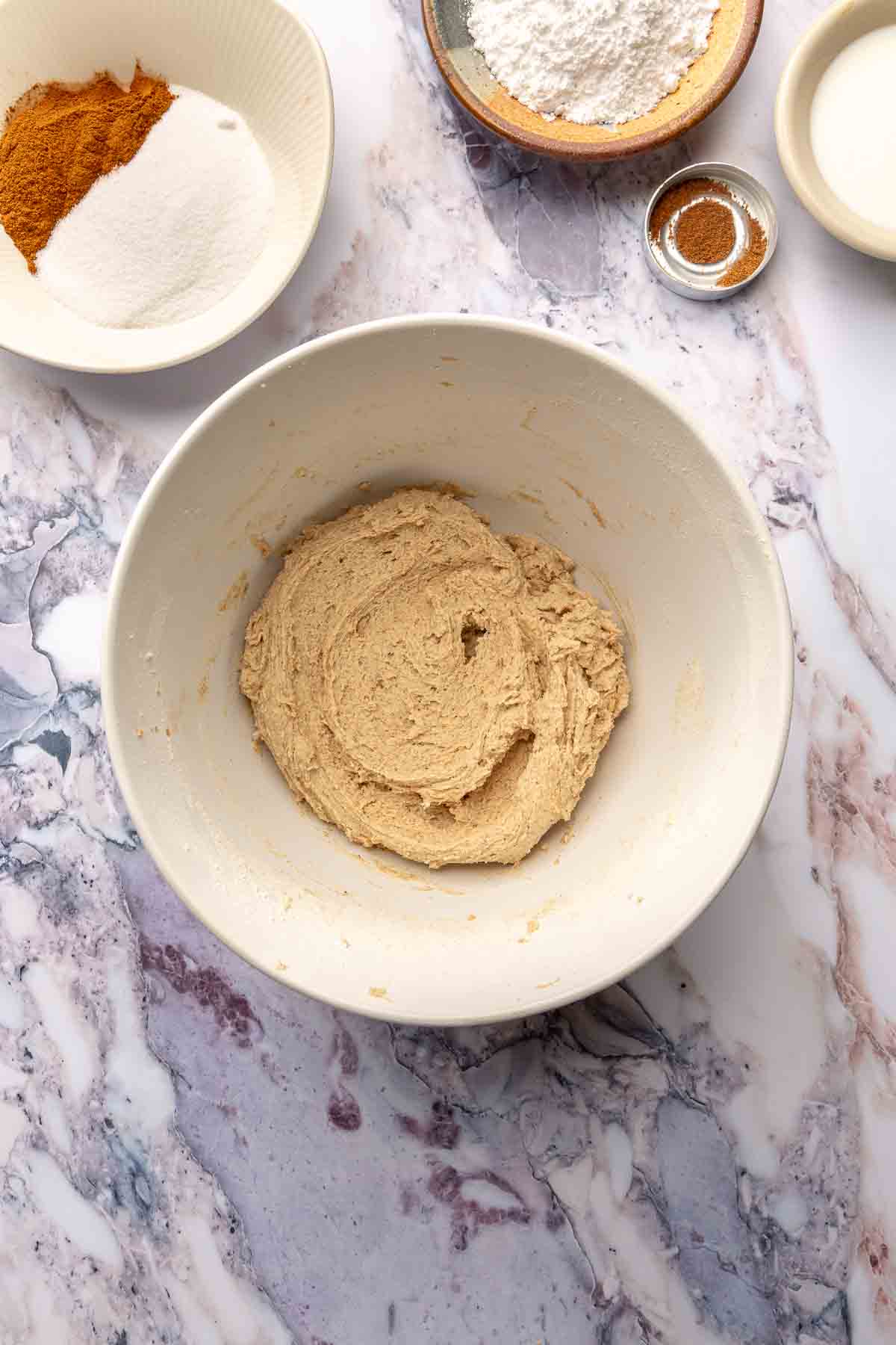 Cookie dough in a large white bowl.