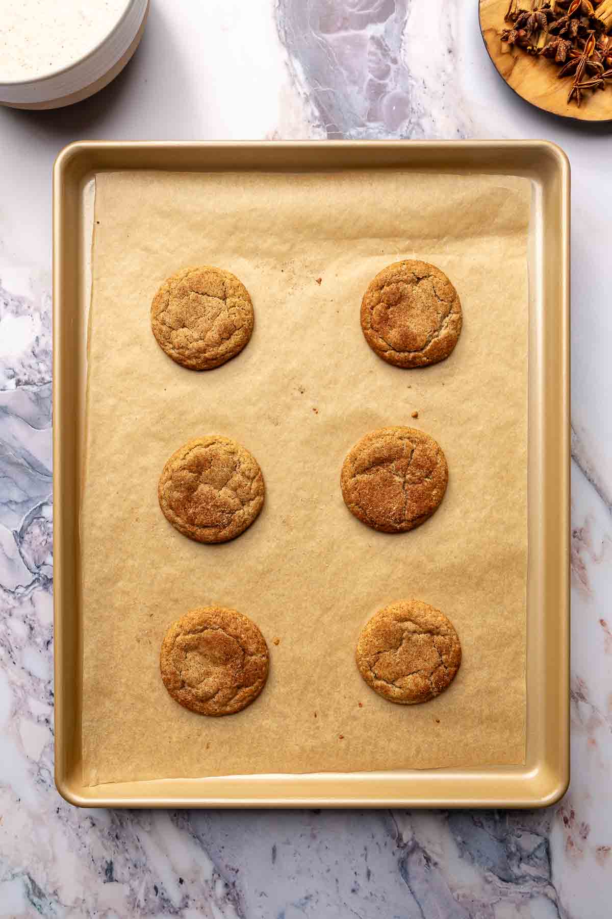 Baked cookies on a pan lined with parchment.