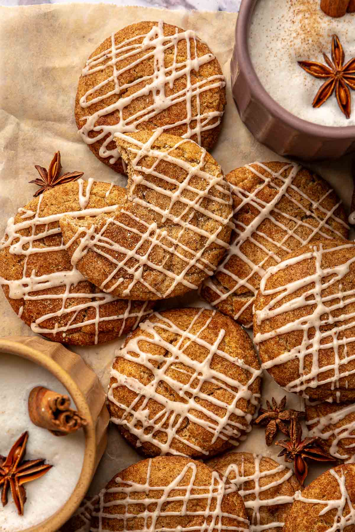 Iced chai cookies on parchment paper served with tea.