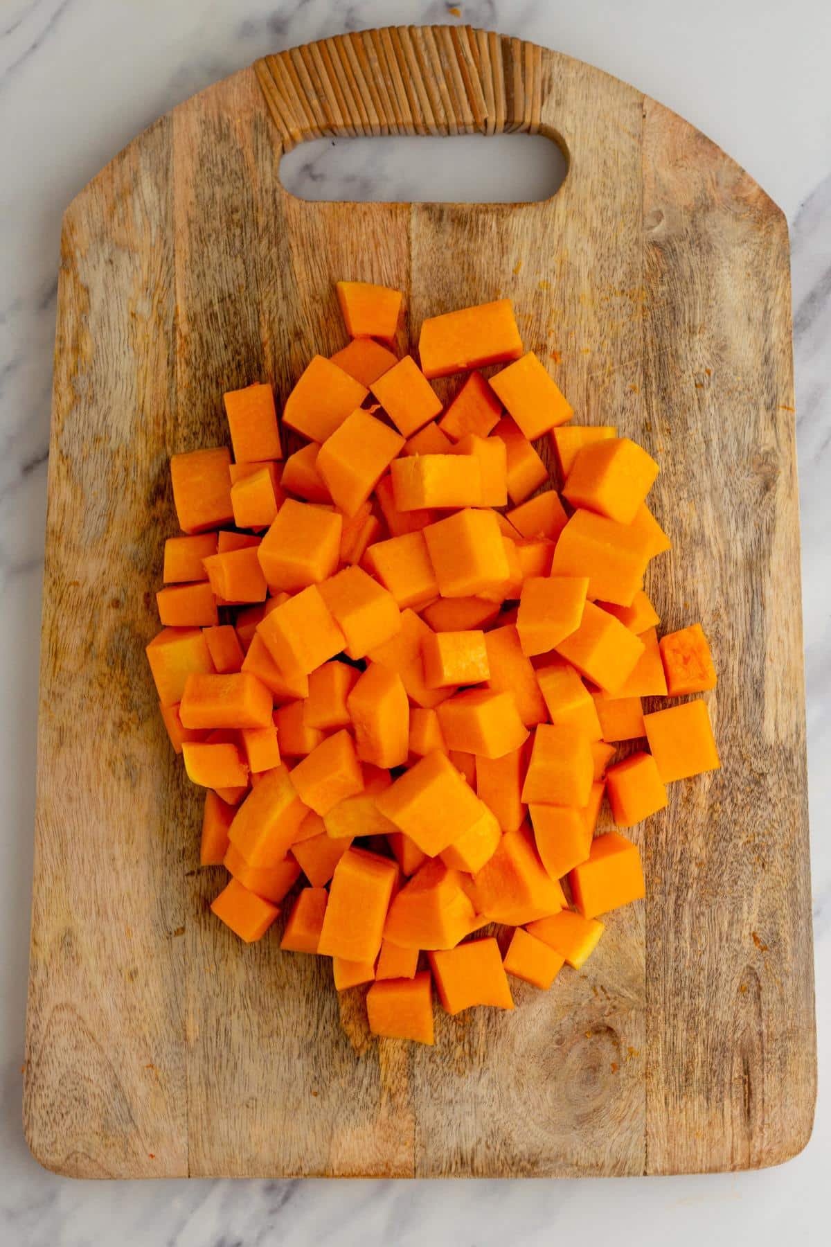 Cubed butternut squash on a cutting board.