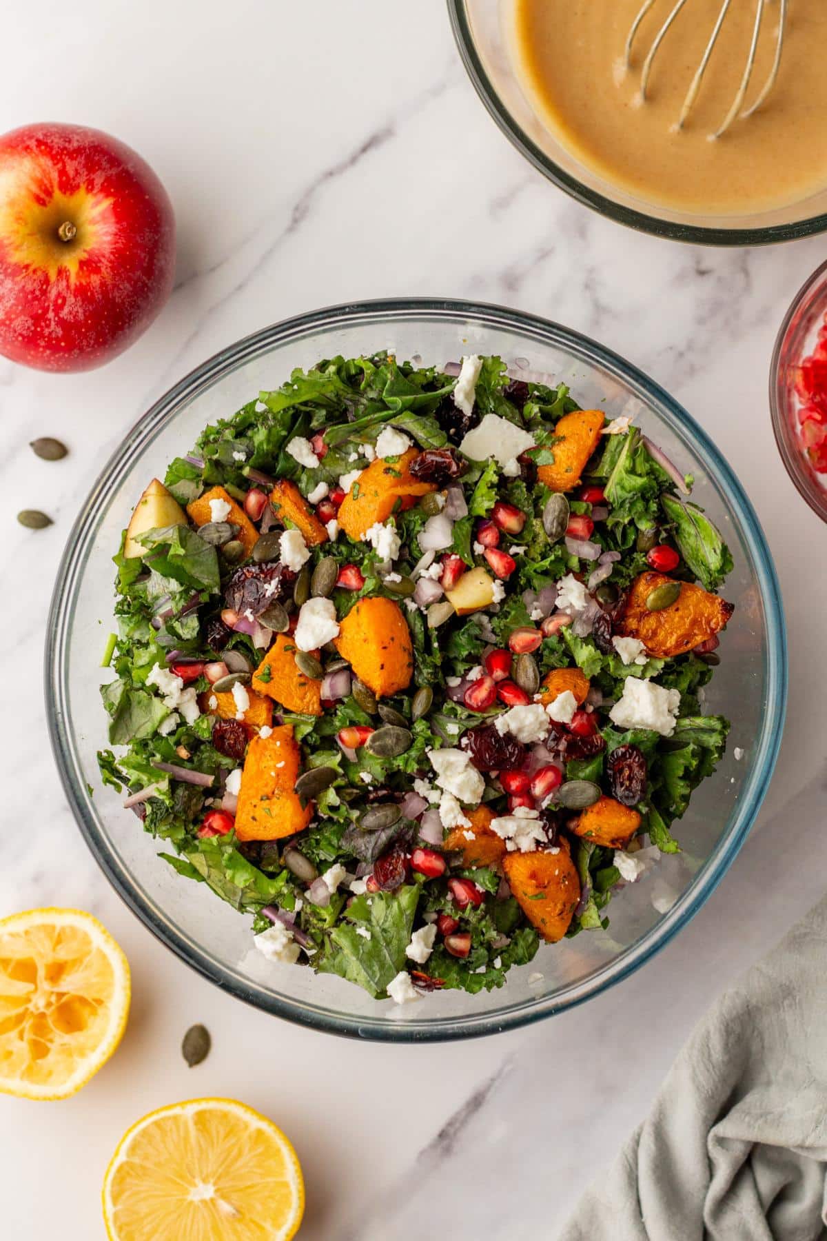 Butternut squash salad mixed in a large glass bowl.