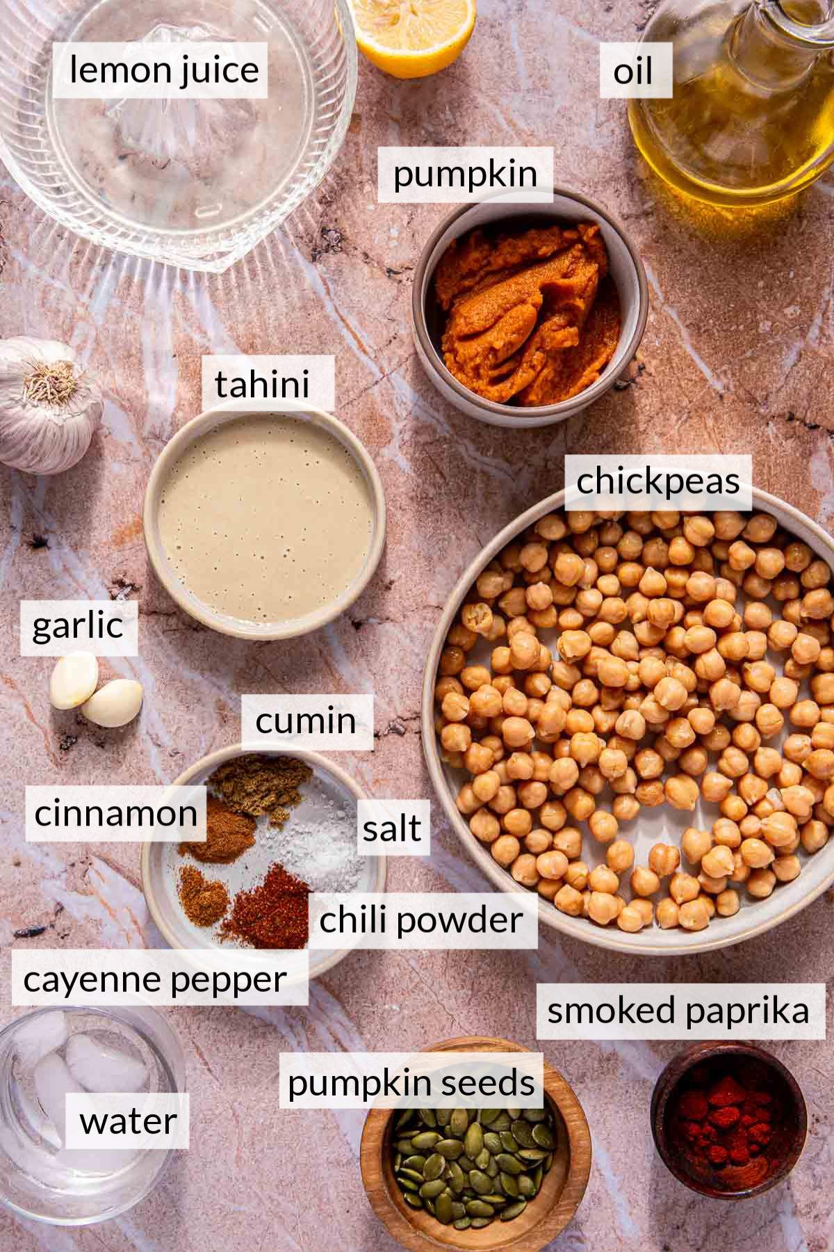 Small bowls with ingredients like pumpkin puree, lemon juice, oil, chickpeas and spices.