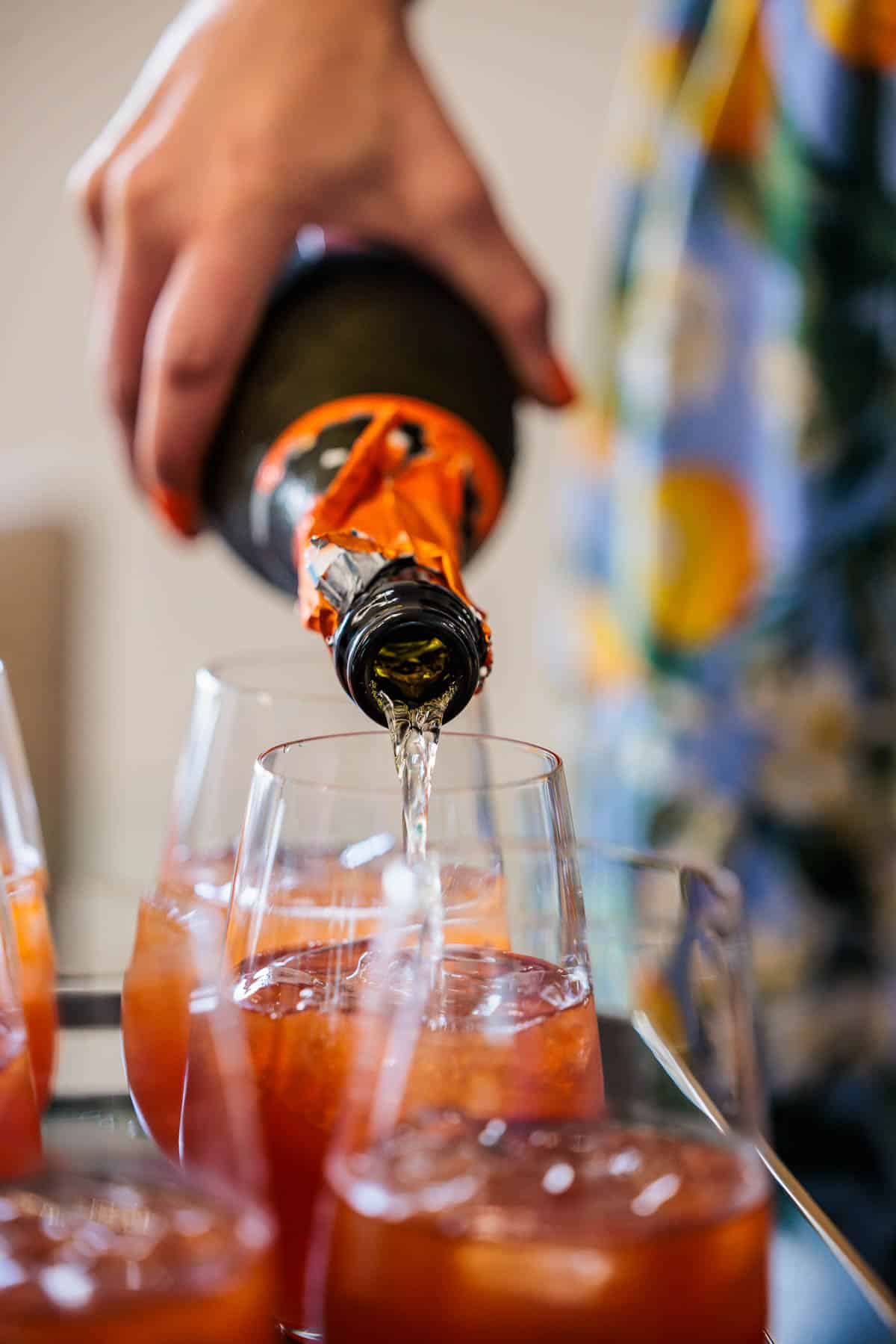 Pouring champagne in a mixed drink.