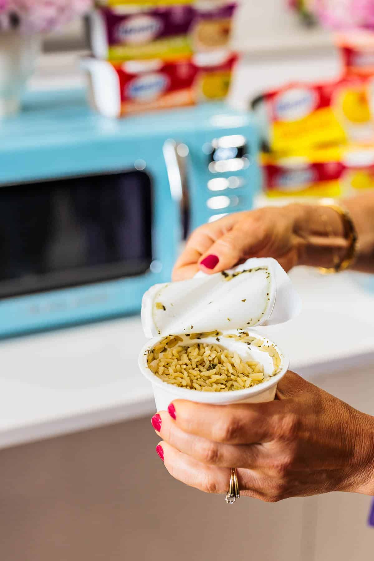 Woman opening a rice cup.