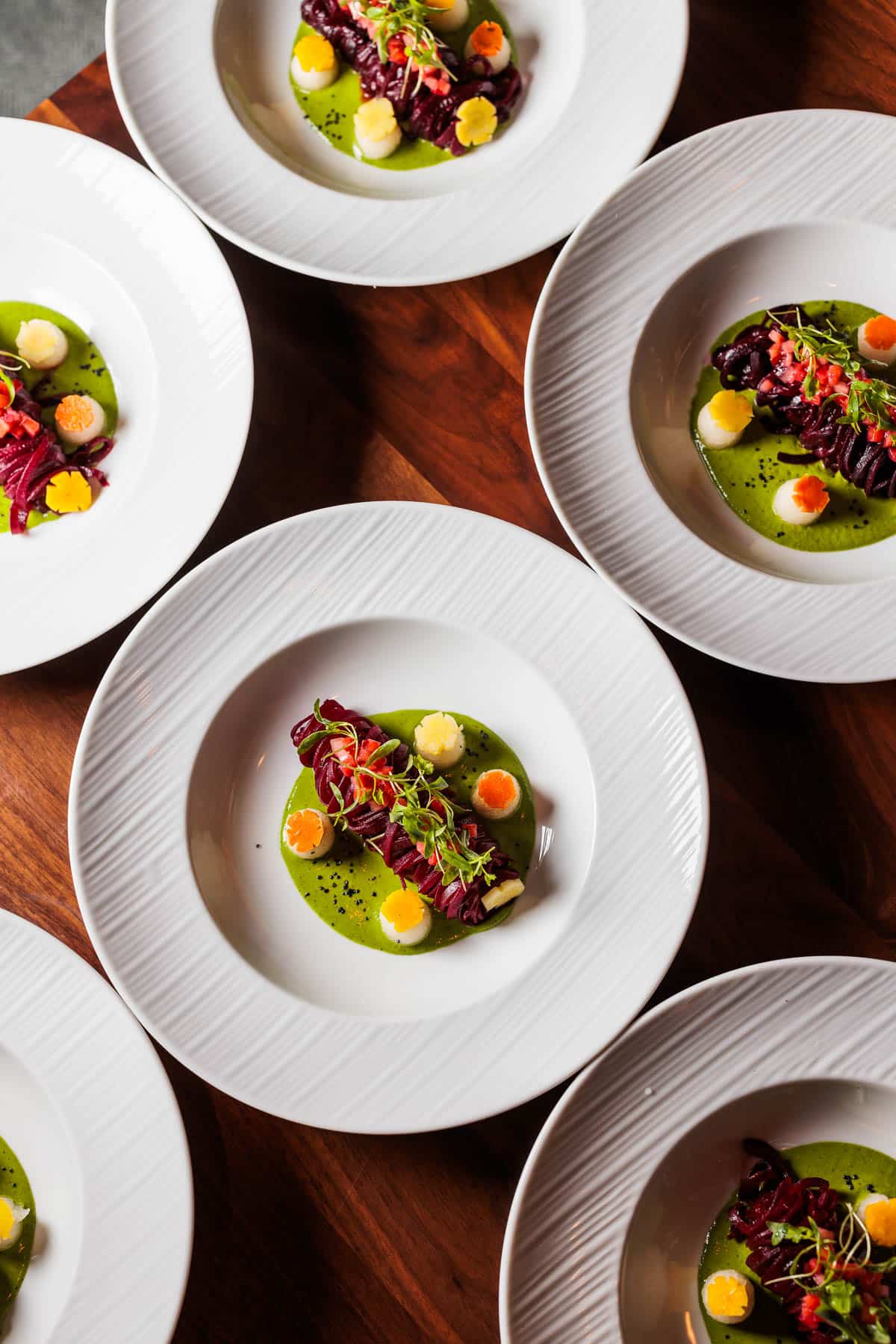 Beet salad plated on white plates.