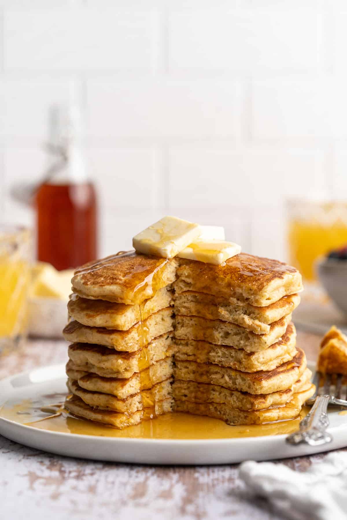 Stack of pancakes on a white plate.