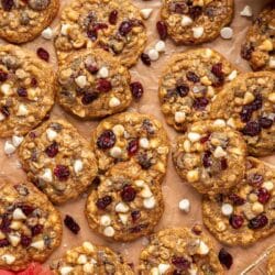 Cranberry oatmeal cookies on parchment paper.