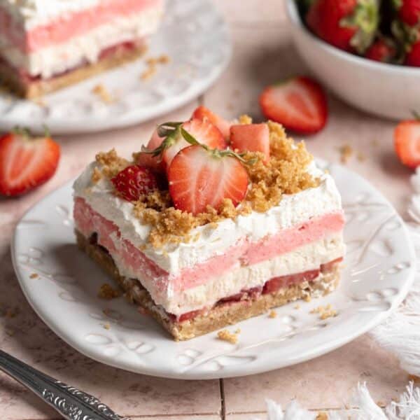 Strawberry Delight on a plate topped with graham cracker crumbs and sliced strawberries.