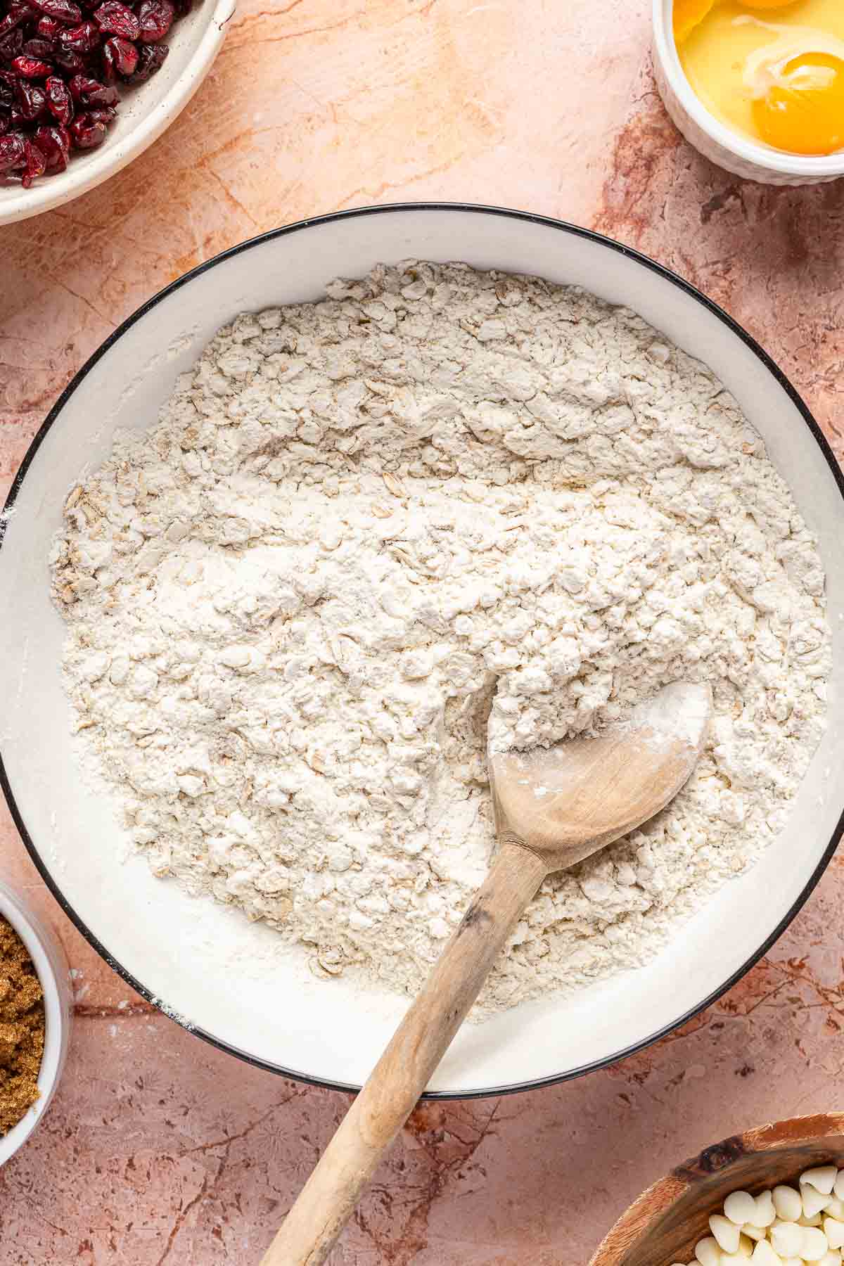 Stirring flour with rolled oats, cornstarch, baking soda and salt. 