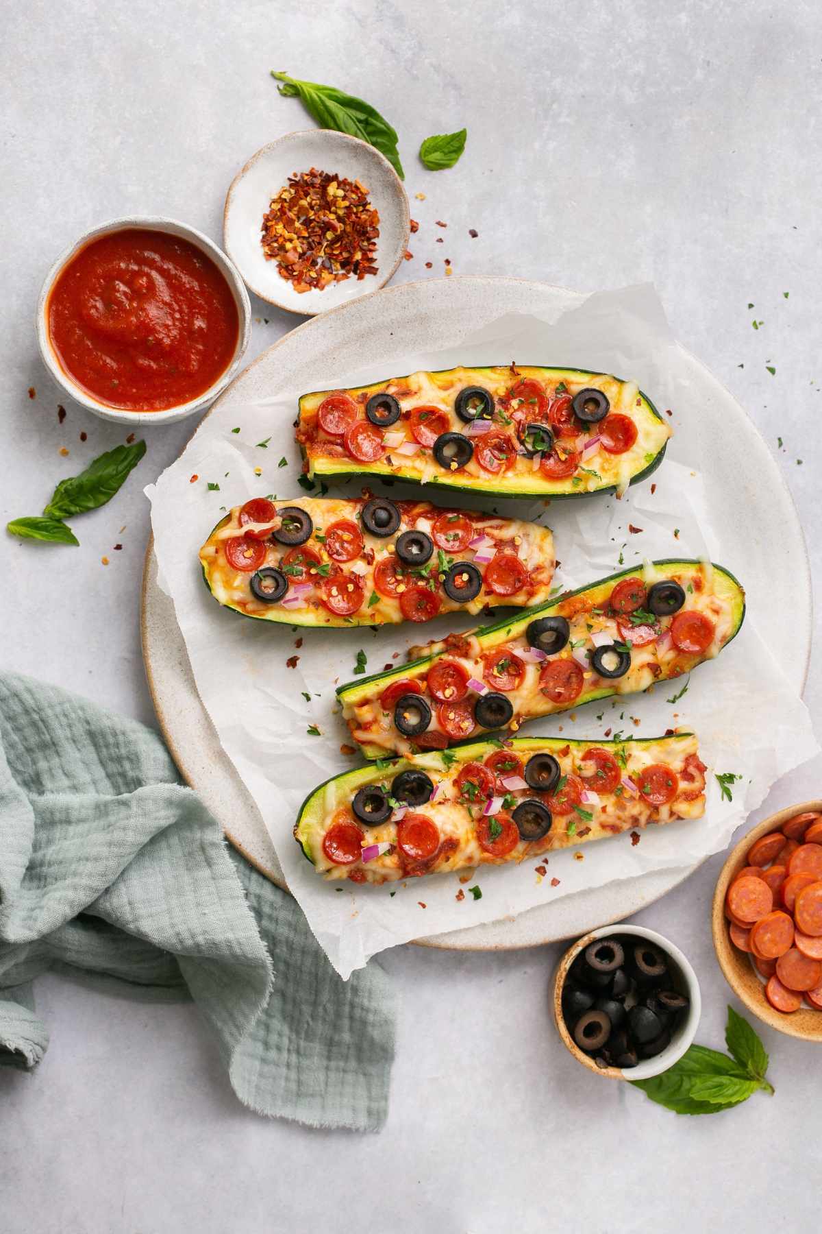 Pizza zucchini boats topped with black olives and mini pepperonis.