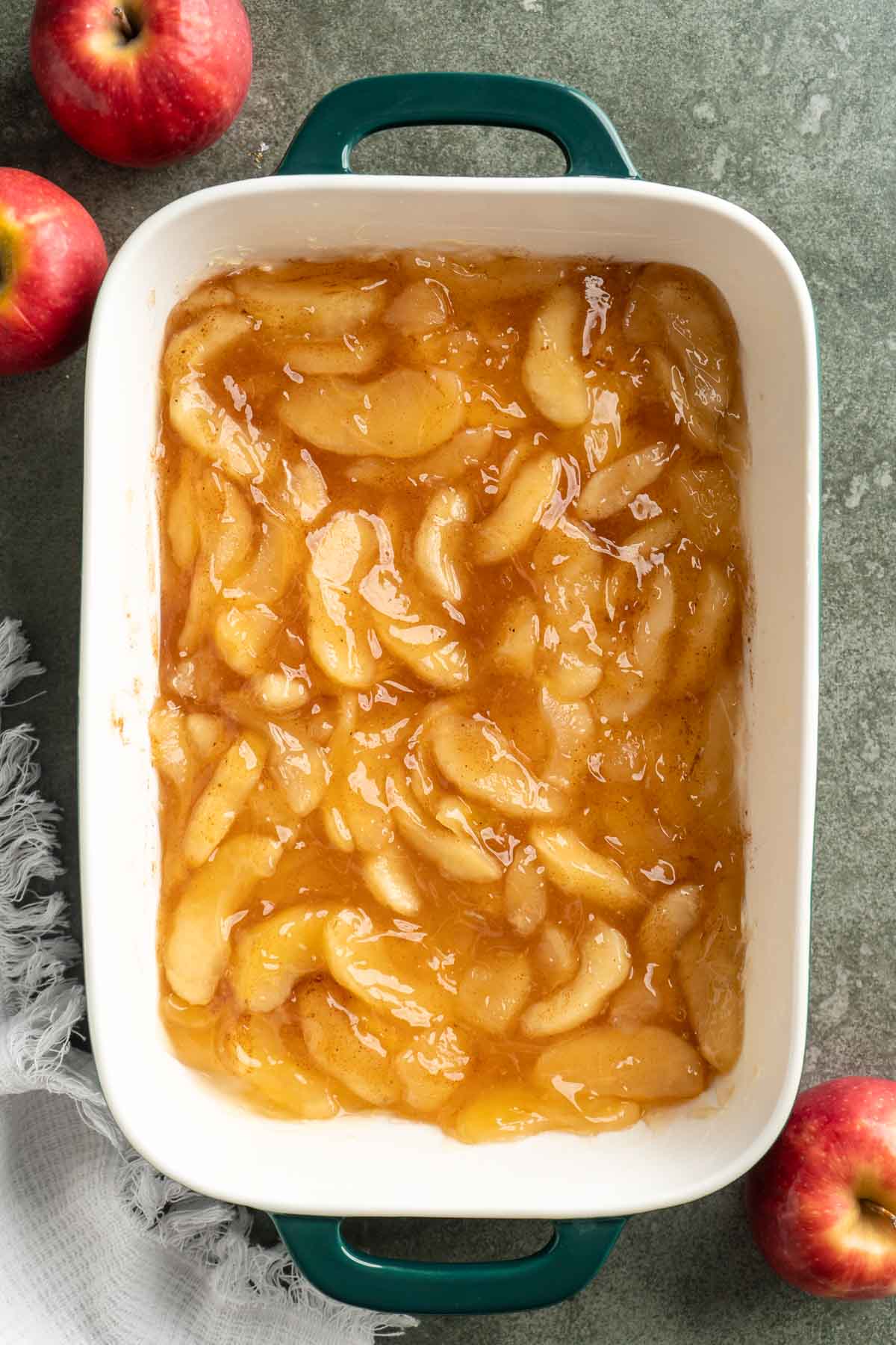 Apple pie filling spread in a 9x13-inch casserole dish.