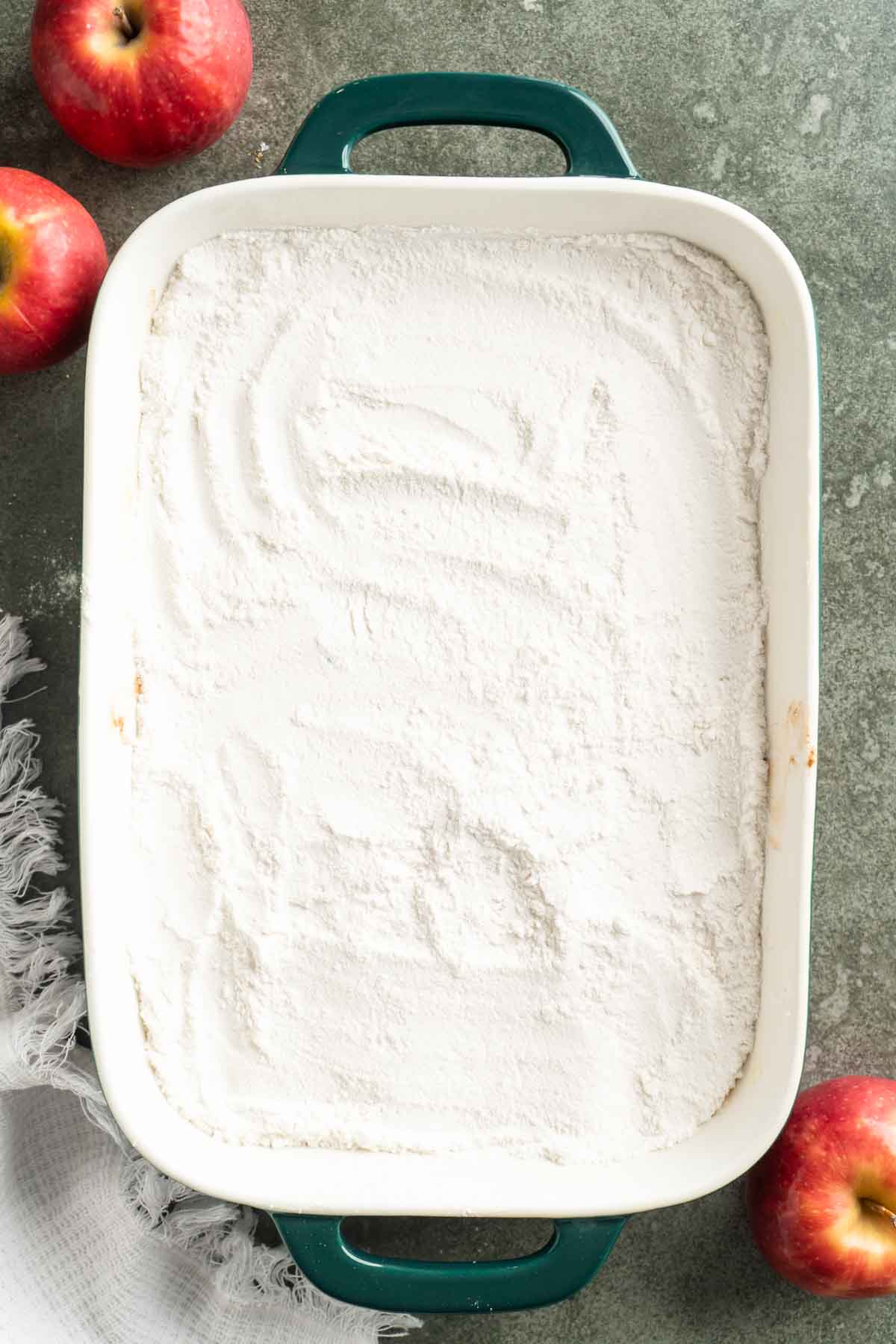 Dry cake mix sprinkled over the top of apple fruit filling.