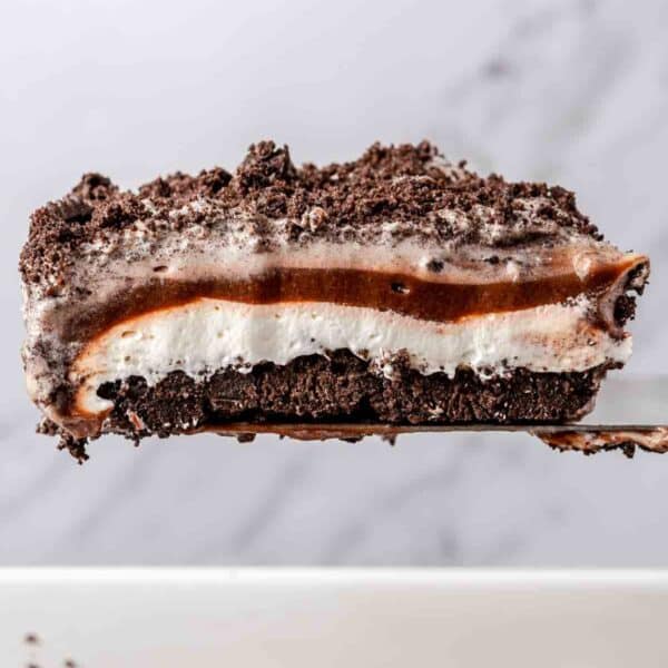 Serving a slice of layered Oreo dessert.