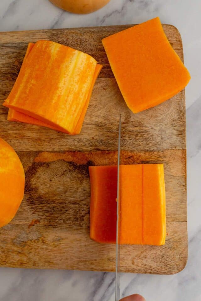 Cutting the butternut squash into slices. 