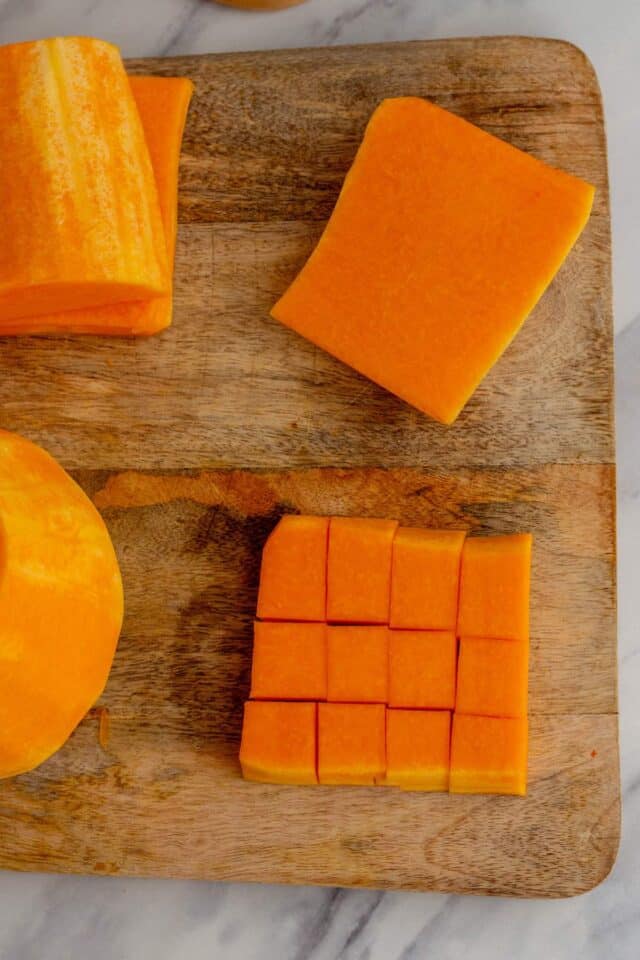 Cubing the slices of the squash.