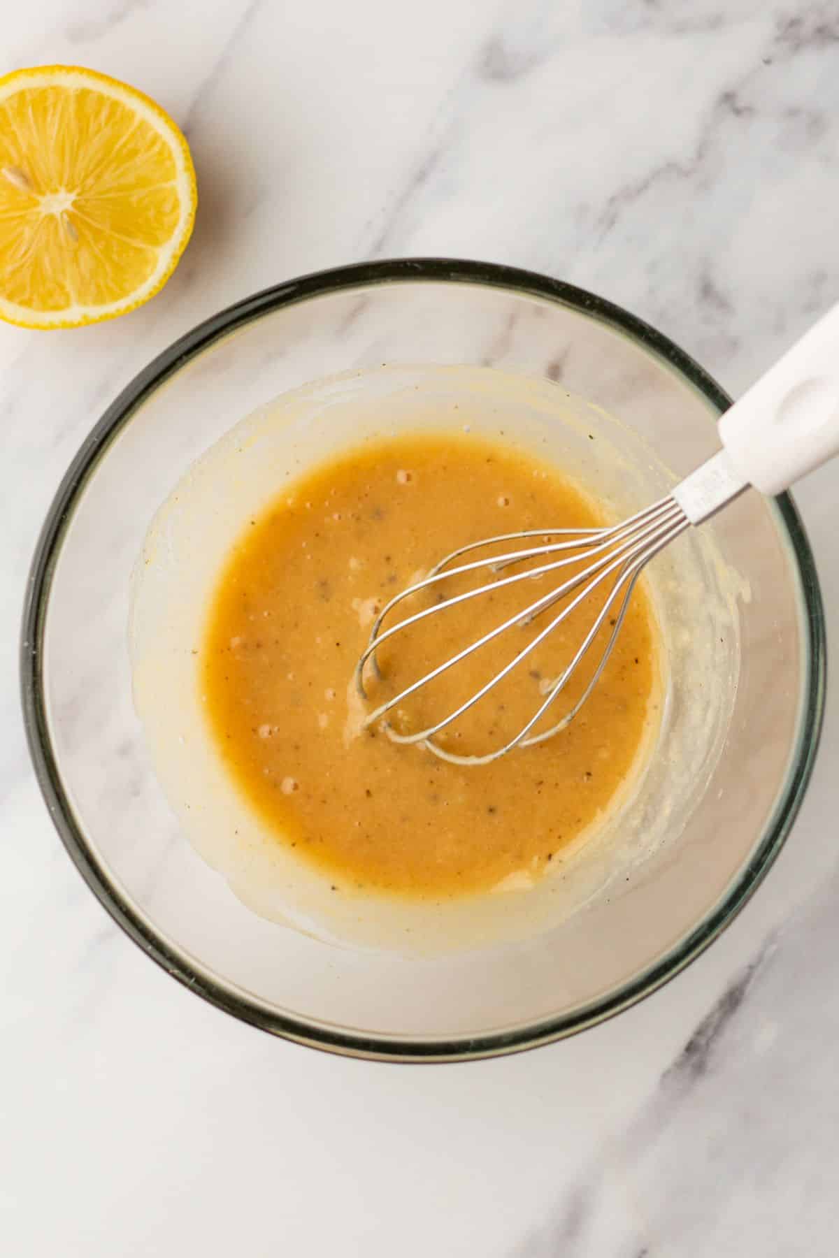 Whisking water in with dressing.