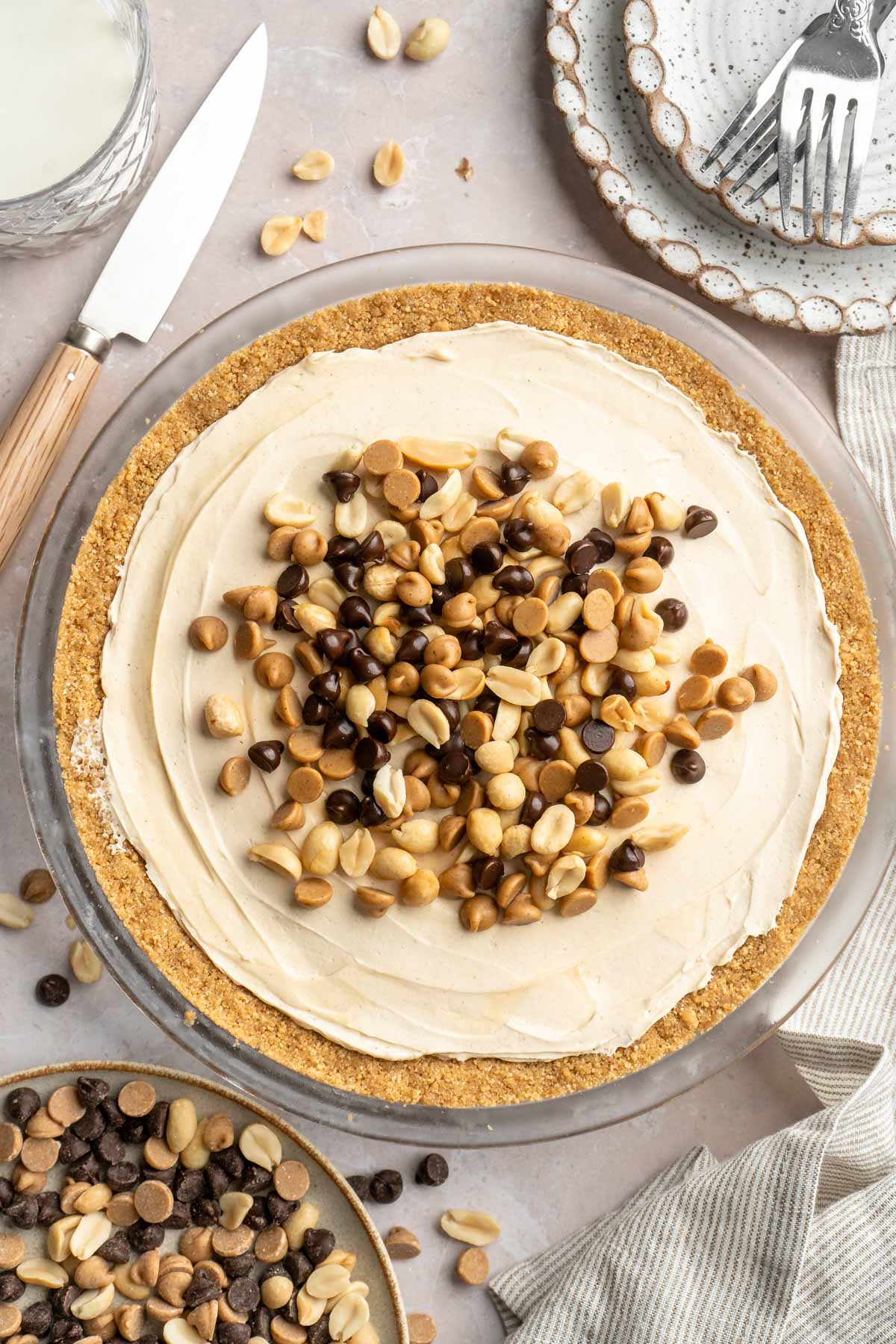 Peanut butter pie garnished with chopped peanuts, peanut butter chips and chocolate chips.