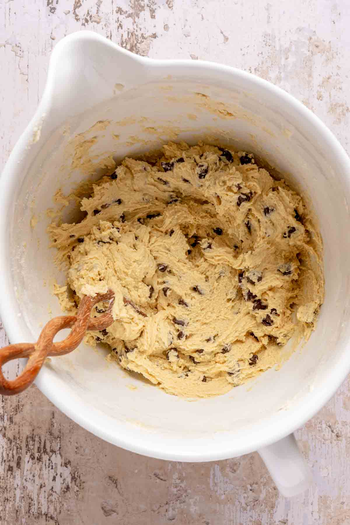 Folding chocolate chips into cookie dough.