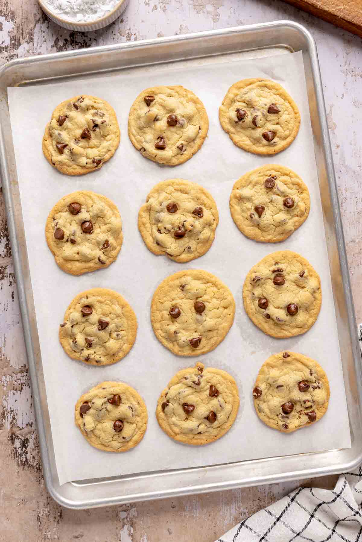 Baked chocolate chip cookies with crisco on a sheet pan.