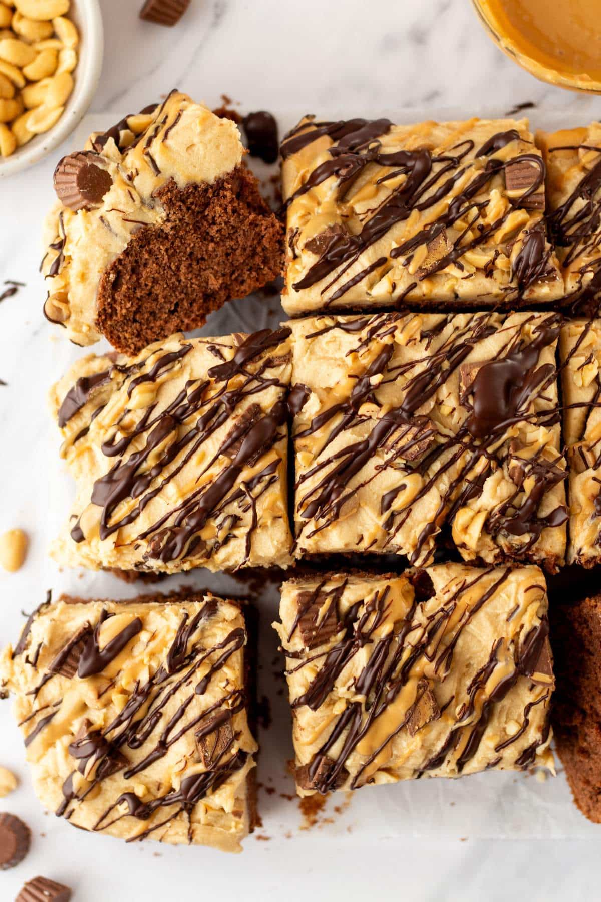 Chocolate peanut butter cake decorated with chocolate drizzle and mini Reese's.